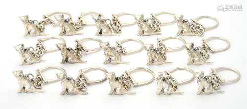 A collection of silver cat key rings