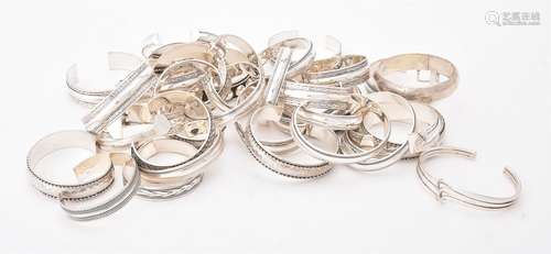 A collection of silver and silver coloured bangles