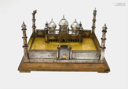 An unmarked silver coloured model of a mosque