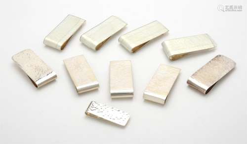 A collection of silver hammered rectangular money clips