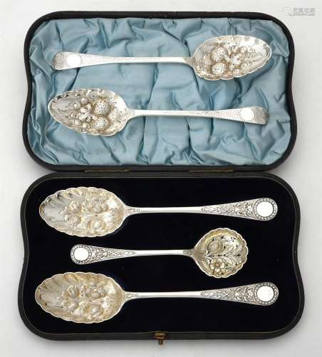 A cased pair of Victorian silver berry spoons and a sifting ...