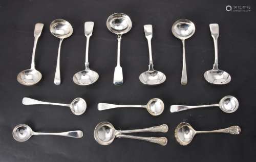 A collection of silver sauce ladles