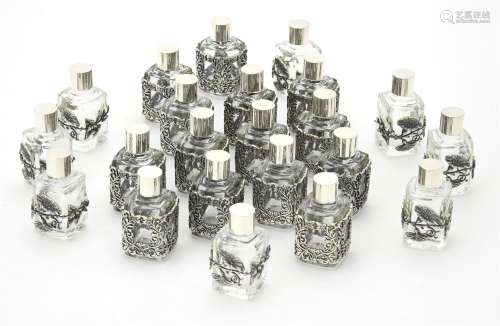 Twenty two glass scent bottles with silver coloured mounts