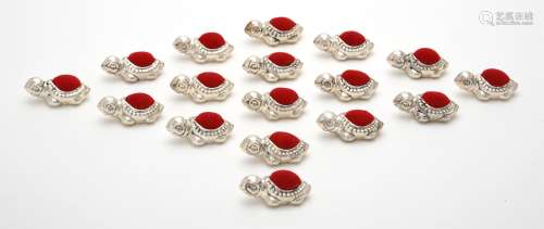 A collection of seventeen silver mounted turtle pin cushions