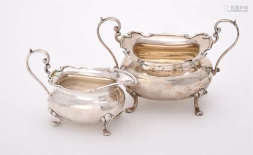 A silver oblong baluster cream jug and sugar basin by Walker...