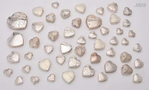 A collection of silver heart shaped boxes