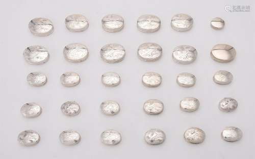 A collection of silver oval boxes