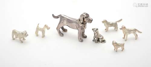 A collection of silver and silver coloured models of dogs