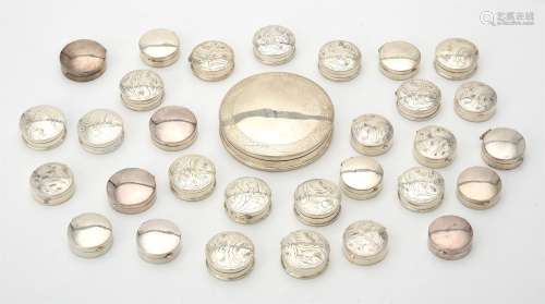 A collection of silver circular boxes