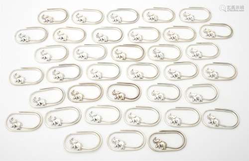 A collection of silver coloured oval clips
