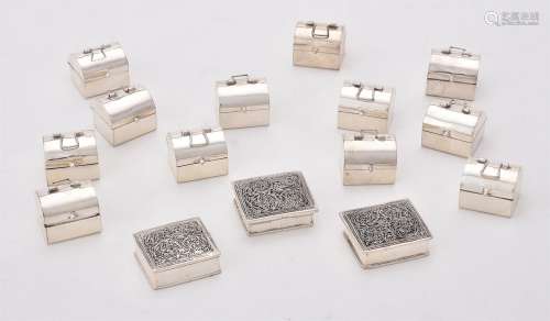 A collection of silver pill boxes