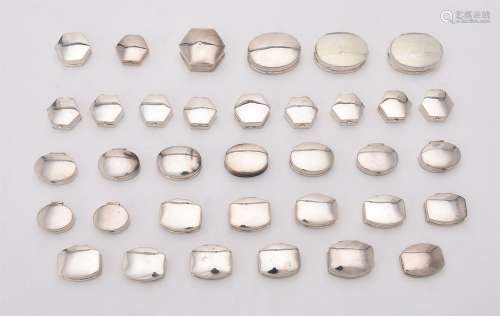 A collection of assorted silver pill boxes