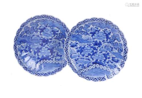 A pair of Arita porcelain blue and white fluted chargers wit...