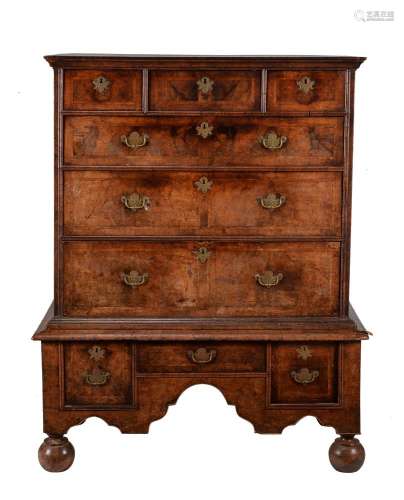A walnut and featherbanded chest on stand