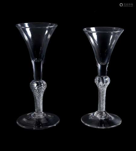 Two similar composite stemmed wine glasses