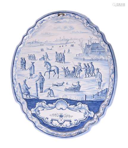 A large Dutch Delft blue and white shaped oval plaque