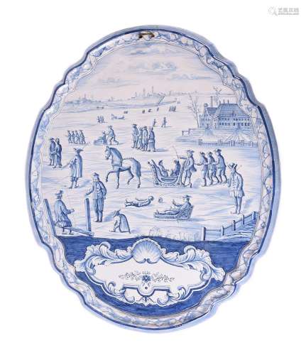 A large Dutch Delft blue and white shaped oval plaque