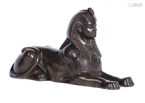 A patinated bronze model of a sphinx