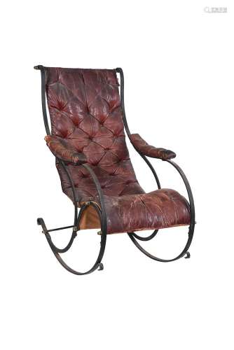 A Victorian cast iron and leather upholstered rocking armcha...