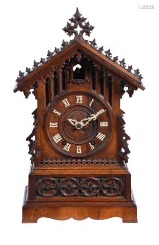 A carved oak and pine mantel clock of Black Forest type