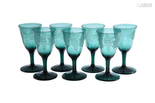 Seven green and engraved plain-stemmed wine glasses