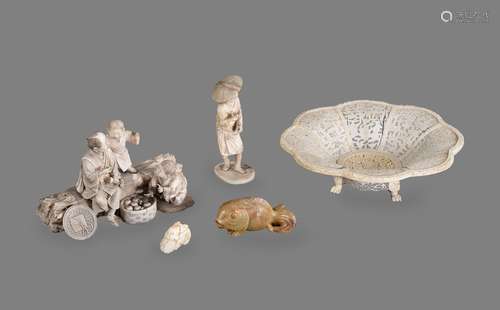 Y A Japanese Ivory Group of a man and boy seated on a large ...