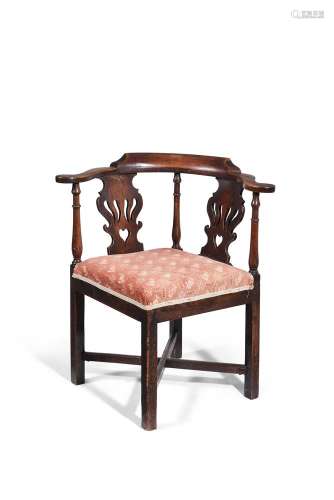 A George III mahogany and upholstered corner armchair