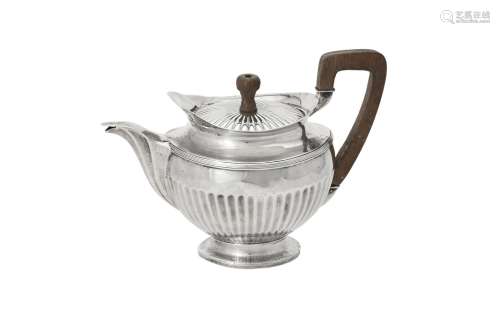 A Dutch silver half fluted circular tea pot