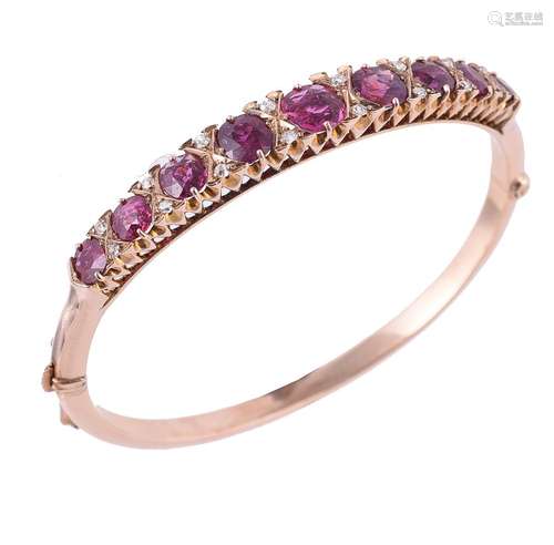 An early 20th century garnet and diamond hinged bangle