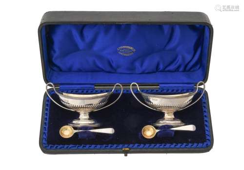 A cased pair of Victorian silver oval pedestal salts by Char...