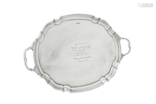 A silver twin handled shaped oval tray by James Deakin & Son...