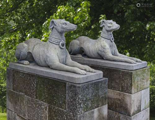 A pair of sculpted limestone models of recumbent hounds