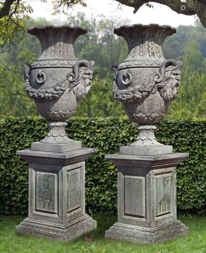A pair of impressive carved limestone urns