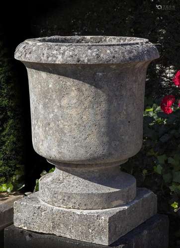 A carved limestone garden urn