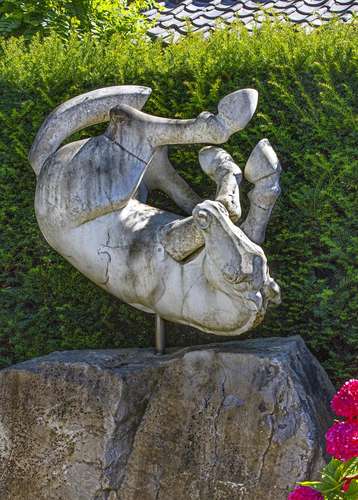 A sculpted marble model of a rolling horse