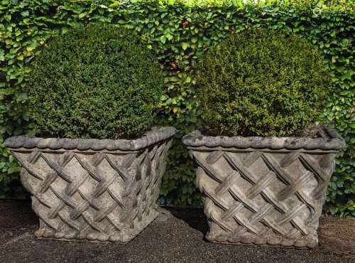 A pair of stone composition planters modelled as baskets