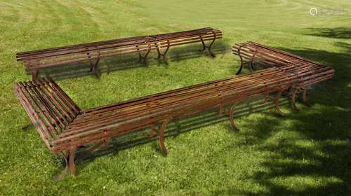 A set of five wrought iron garden benches constituting an op...