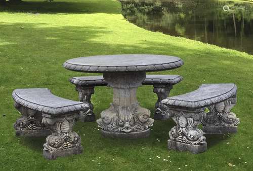 A suite of carved limestone garden furniture