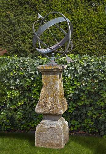 A patinated bronze mounted carved limestone armillary sphere