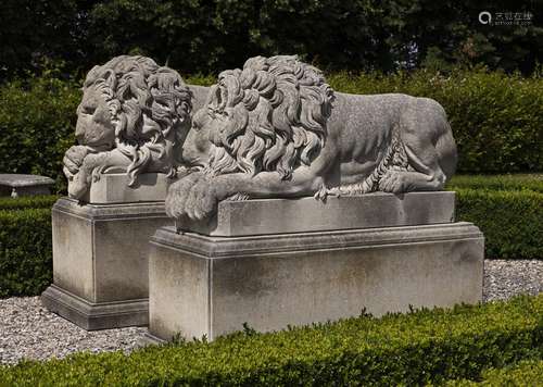 A pair of sculpted limestone models of recumbent lions