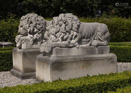 A pair of sculpted limestone models of recumbent lions