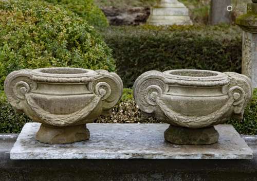 A pair of sculpted sandstone planters