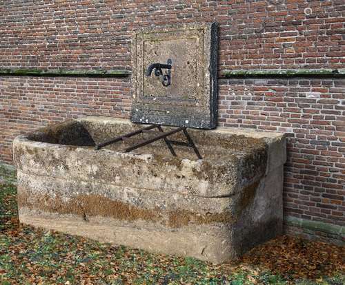 A wall fountain and trough