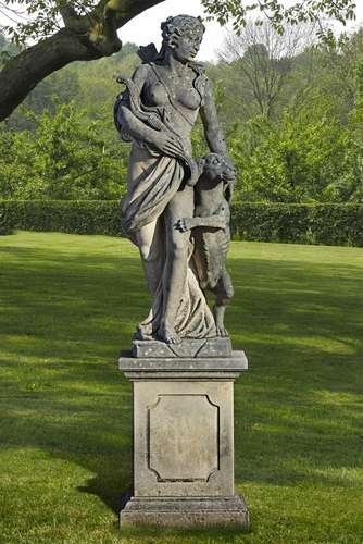 A sculpted stone garden figure of Diana the huntress