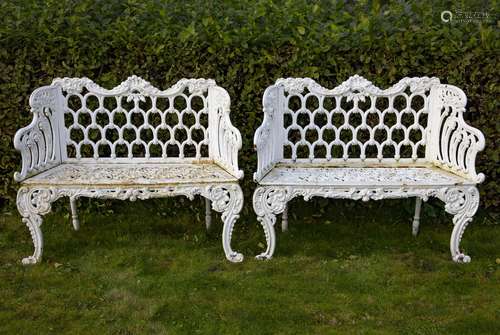 A pair of white painted cast iron garden seats