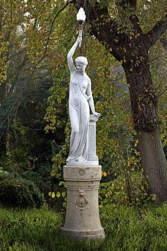 A French white painted cast iron figural torchere