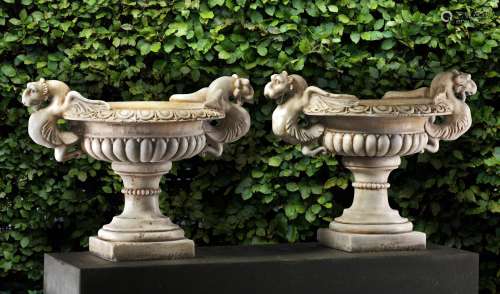 A pair of Continental sculpted white marble garden urns in N...