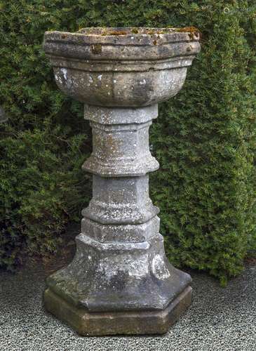 A carved limestone font