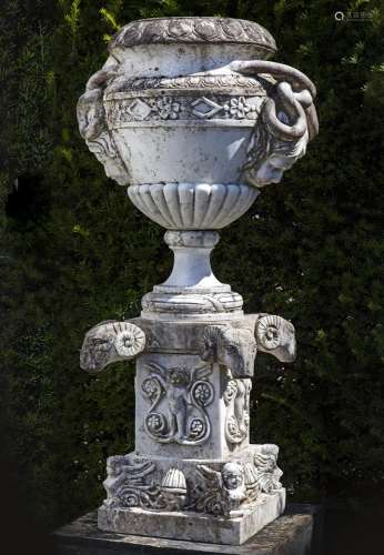 An Italian sculpted Carrara marble urn on pedestal