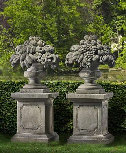 A pair of sculpted limestone pier finials modelled as vases ...